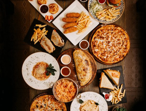 top-view-meals-tasty-yummy-different-pastries-dishes-brown-surface